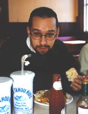 Enjoying a Garbage Plate with tabasco and ketchup at Nick Tahou's